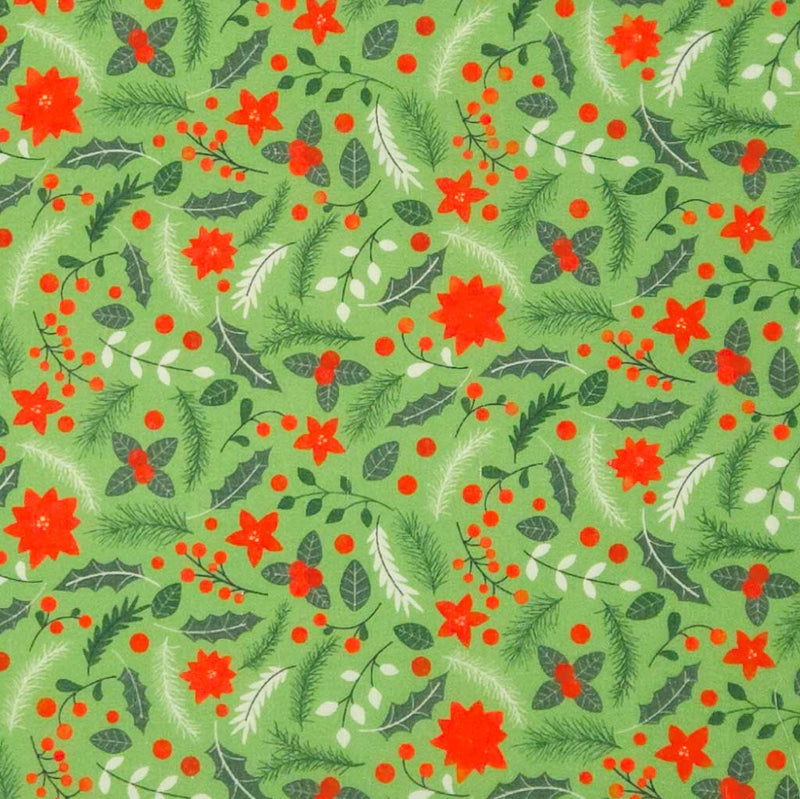 Christmas-themed pattern with red flowers, green leaves, and berries on a green polycotton fabric