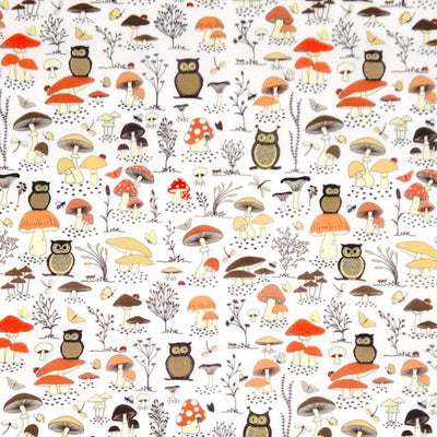 Pattern of owls and mushrooms on a white polycotton fabric