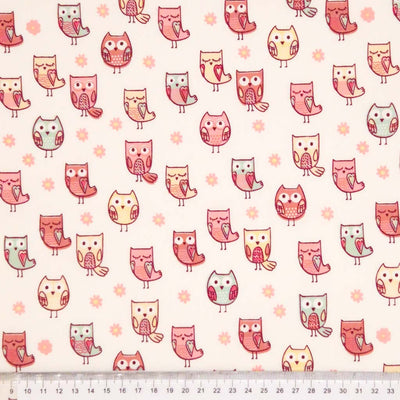 A cute owl and daisy design printed on a cream, 100% cotton poplin fabric with a cm ruler