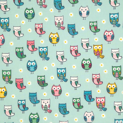 Owls printed on a mint cotton poplin fabric