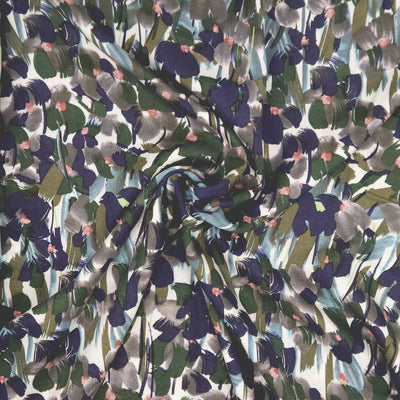 Pattern of abstract shapes in various colours on a white viscose fabric
