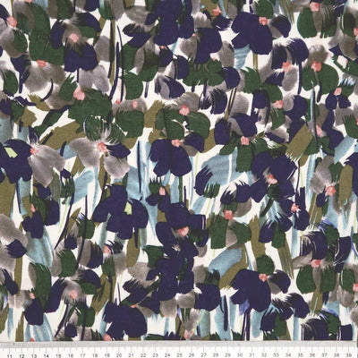 Pattern of abstract shapes in various colours on a white viscose fabric with a cm ruler