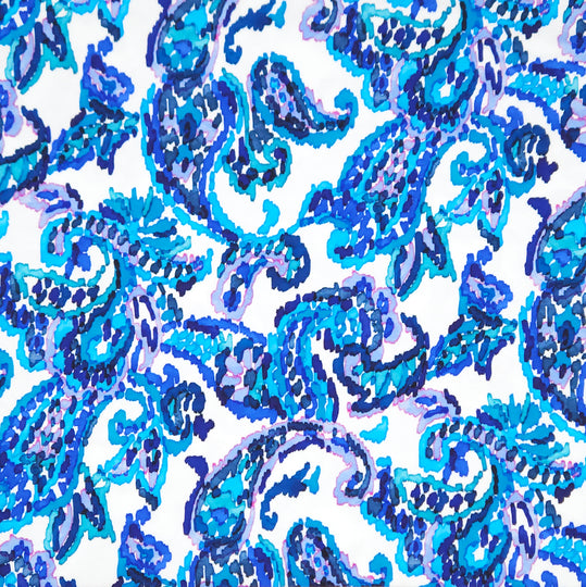 A blue paisley design printed on a white cotton jersey fabric