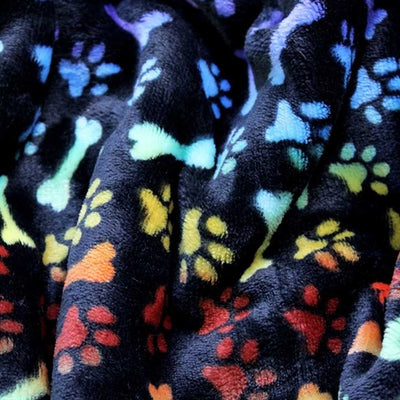 Rainbow coloured paw and bones printed on a black bubs cuddle fleece