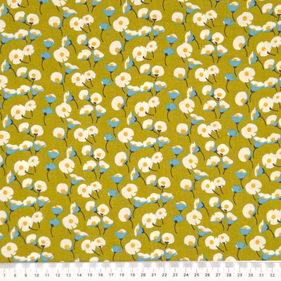 Daisies printed on an olive green pima cotton lawn fabric with a cm ruler.