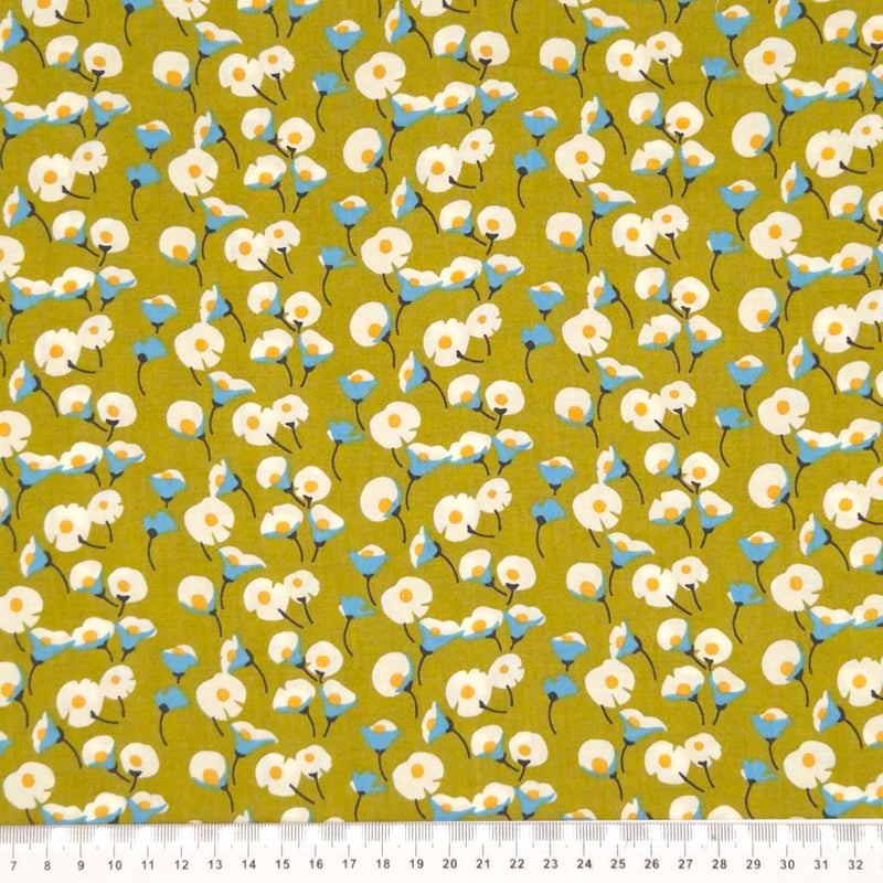 Daisies printed on an olive green pima cotton lawn fabric with a cm ruler.