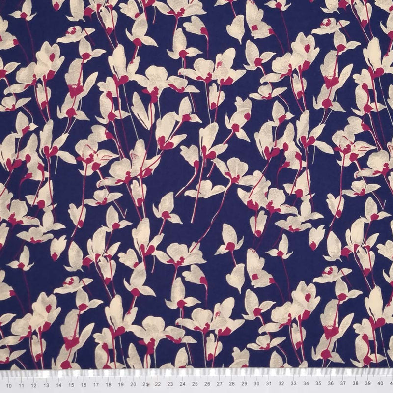 Ivory coloured petals are printed on a navy pima cotton lawn fabric with a cm ruler