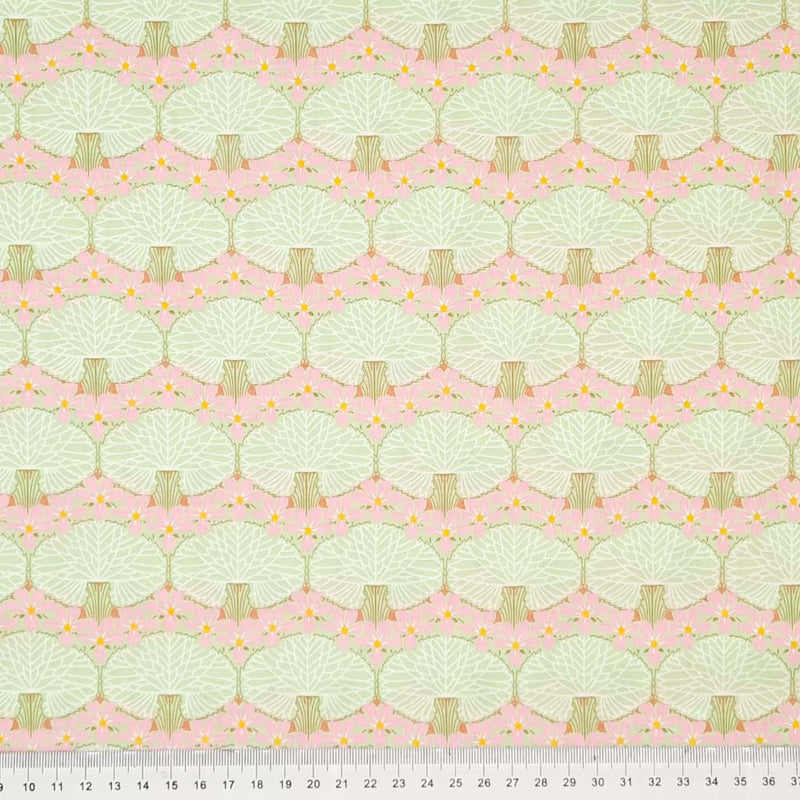 Mint coloured trees printed on a blush pink pima cotton lawn fabric with a cm ruler