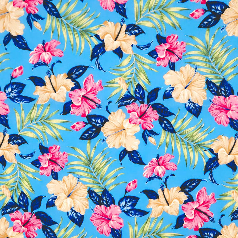 Hibiscus flowers printed on a sky blue cotton poplin fabric