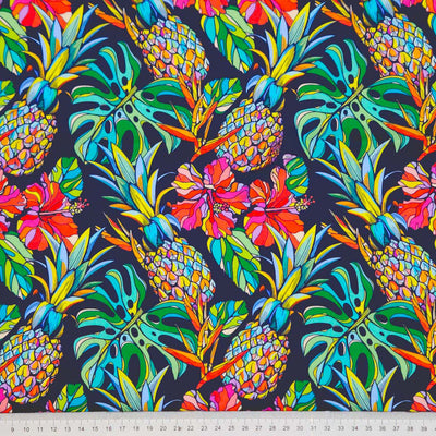 Pineapple and hibiscus printed on a navy cotton poplin fabric with a cm ruler