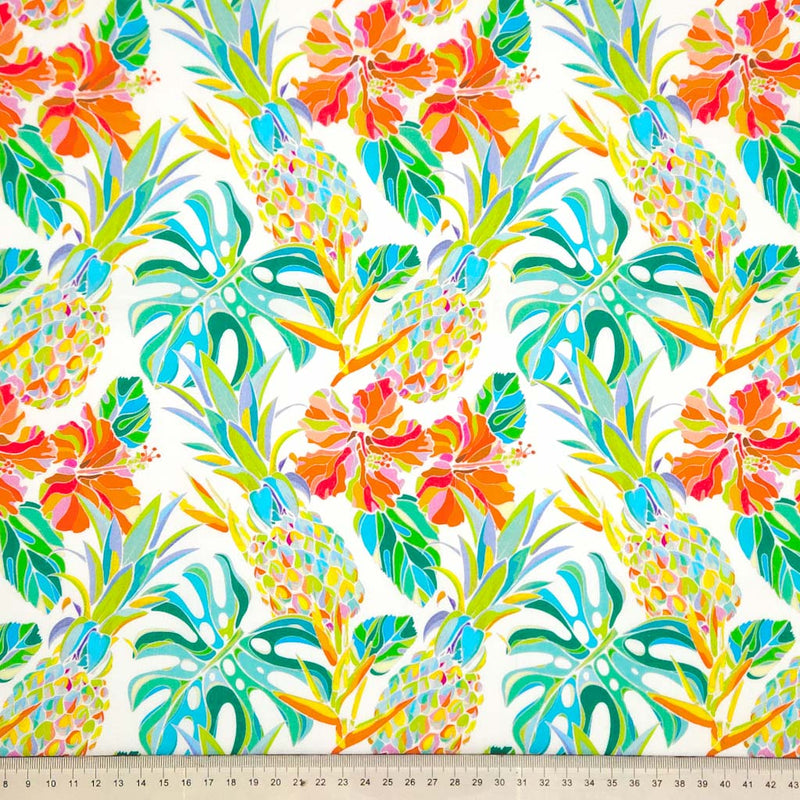 Pineapple and hibiscus printed on an ivory cotton poplin fabric with a cm ruler