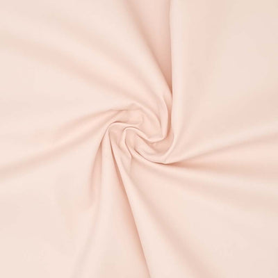 A blush plain cotton poplin fabric