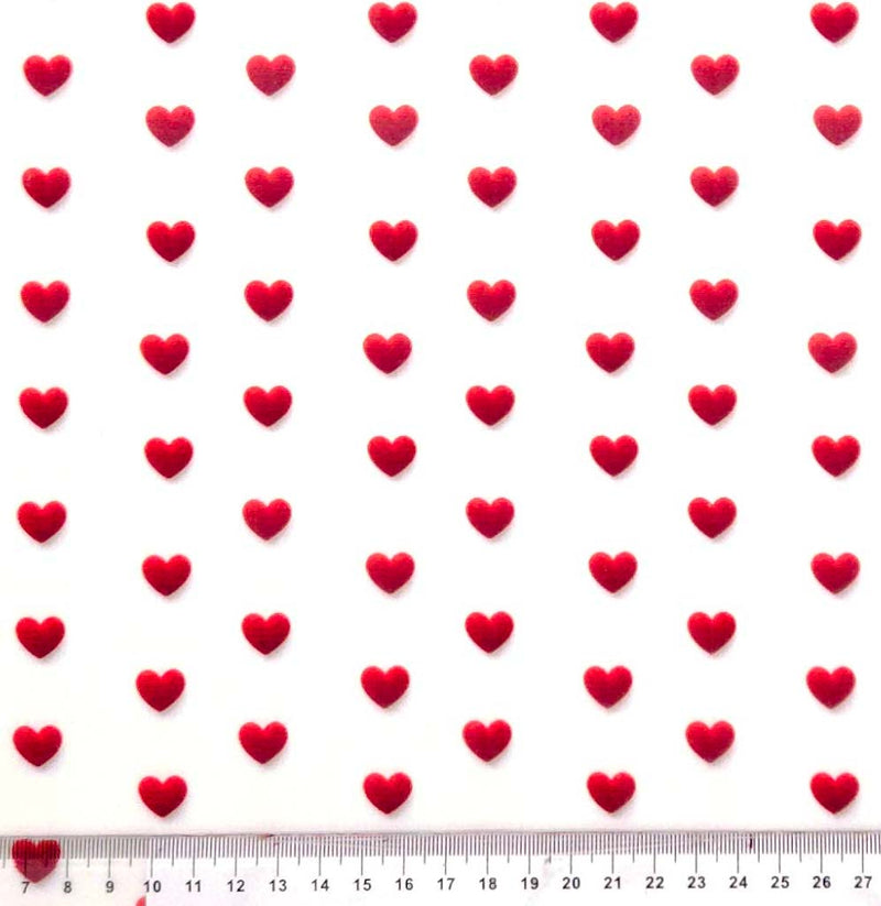 Pattern of red hearts on a white polycotton fabric with a ruler at the bottom.