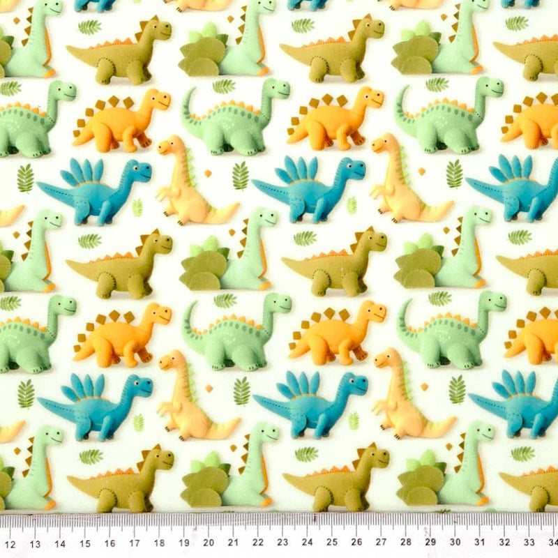 Pattern of colourful cartoon dinosaurs on a white polycotton fabric with a ruler at the bottom.