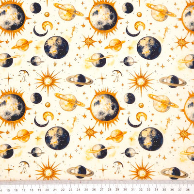 Pattern of celestial bodies including planets, stars, and suns on a white cotton fabric with a ruler at the bottom.