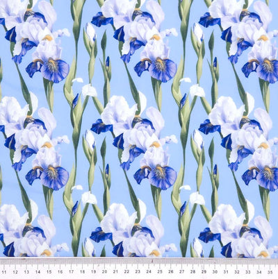 Pattern of blue and white flowers on a light blue polycotton fabric with a ruler at the bottom.