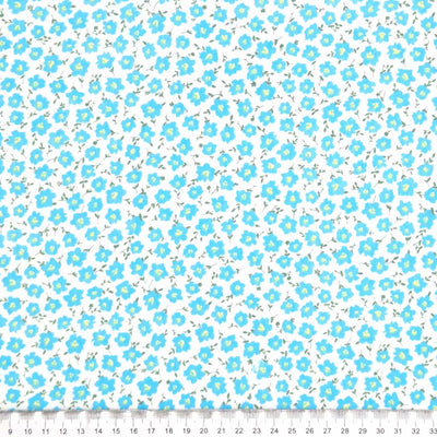 Ditsy blue peonies printed on a white polycotton fabric with a cm ruler