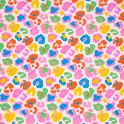 A fun leopard print with colourful leopard spots on a pink polycotton