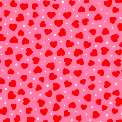 Red ditsy hearts printed on a pink polycotton fabric