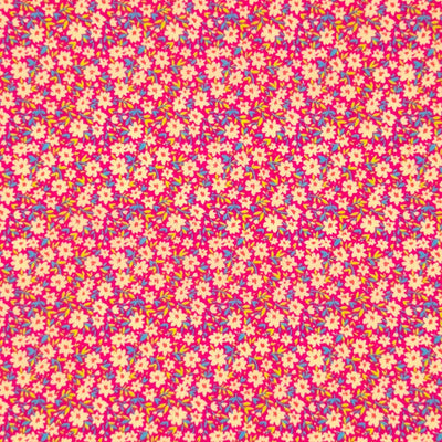Ditsy flowers and sky blue green vines on a dusk pink polycotton fabric