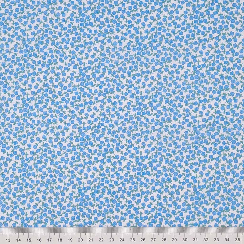 Ditsy blue flowers are printed on a white, quality polycotton fabric with a cm ruler