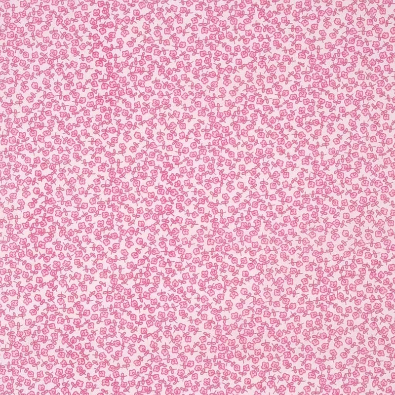 Ditsy pink flowers printed on a white polycotton fabric