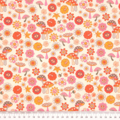 Mushrooms printed on a pale pink polycotton fabric with a cm ruler