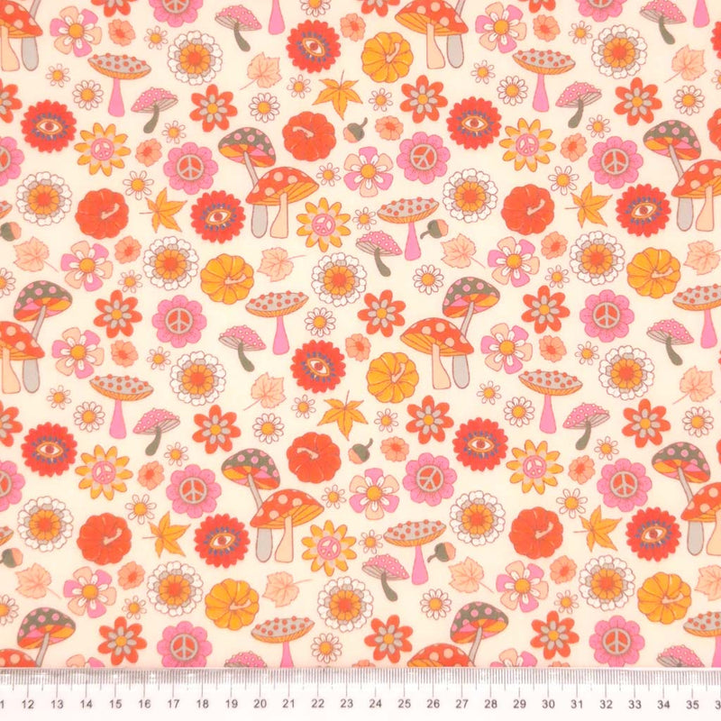 Mushrooms printed on a pale pink polycotton fabric with a cm ruler