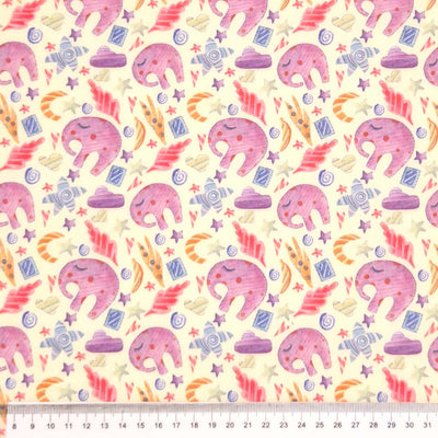 Lilac elephants printed on a cream polycotton fabric with a cm ruler