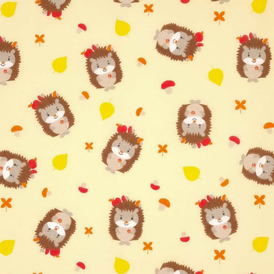 Cute hedgehogs and toadstools are printed on a cream polycotton fabric