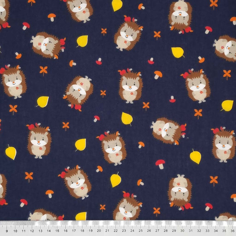 Cute hedgehogs and toadstools are printed on a navy polycotton fabric with a cm ruler