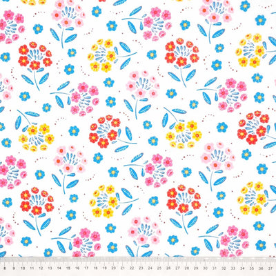 A floral design with flowers as petals printed on a white polycotton fabric with a cm ruler