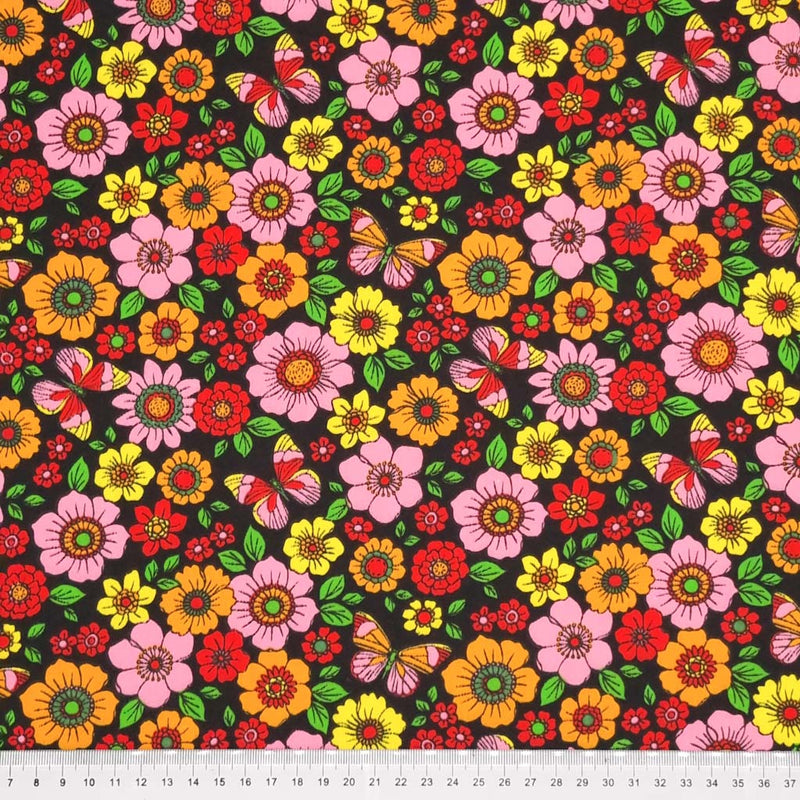 Beautiful butterflies and colourful flowers are printed on a black polycotton fabric with a cm ruler