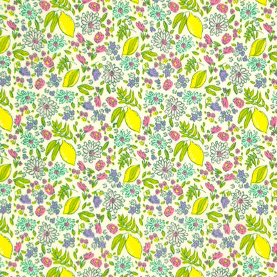 Lemons and ditsy flowers printed on a white polycotton fabric