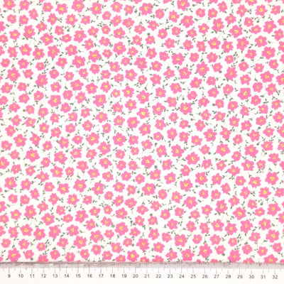 Pink peonies printed on a white polycotton fabric with a cm ruler