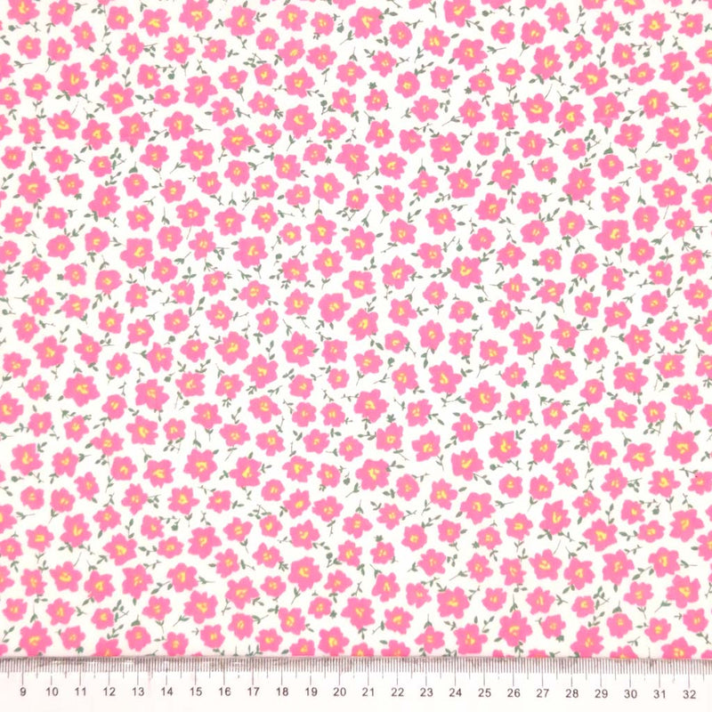 Pink peonies printed on a white polycotton fabric with a cm ruler