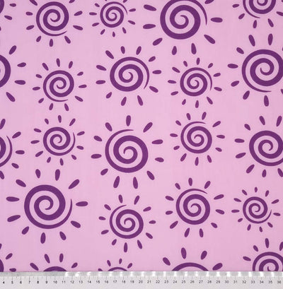 Purple swirly suns are printed on a lilac polycotton fabric with a cm ruler