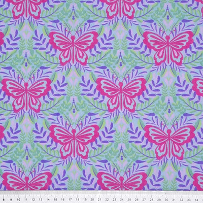 Large butterflies in cerise are printed on a lilac and sky blue coloured polycotton fabric with a cm ruler