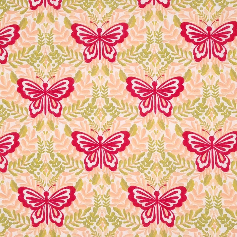Large magenta butterflies printed on a peach and green polycotton fabric