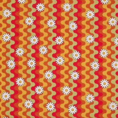 Daisies are printed with a retro squiggle pattern in vibrant reds and green colours on a polycotton fabric