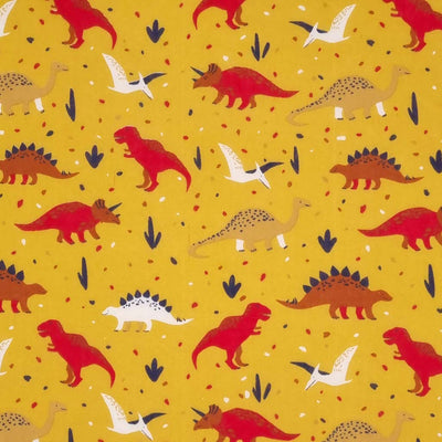 Red and brown dinosaurs printed on a mustard yellow polycotton fabric