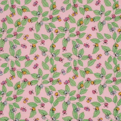 Pink and yellow ladybirds printed on a pink polycotton fabric