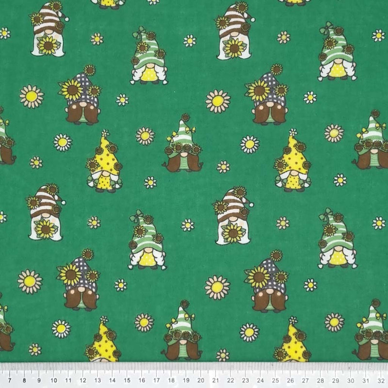 Cute little gonks with daisies are printed on a bottle green polycotton fabric with a cm ruler