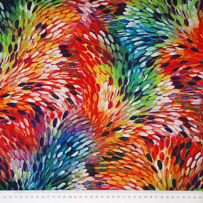 Rainbow coloured feathers are printed on a viscose ponteroma fabric with a cm ruler