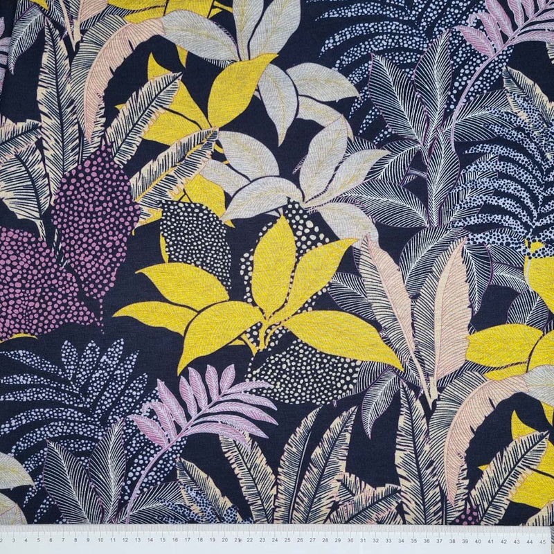 A large floral print on a navy viscose ponteroma dressmaking fabric with a cm ruler