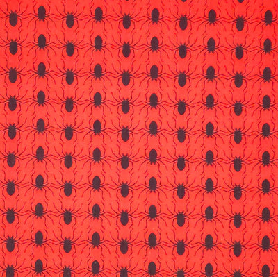 Pattern of black spiders on a red halloween polycotton fabric