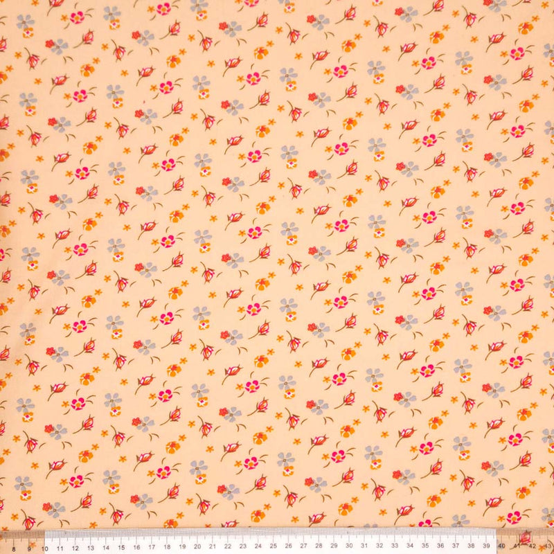Floral patterned fabric with a swirl design on a peach viscose fabric with a ruler