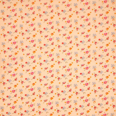 Floral patterned fabric with a swirl design on a peach viscose fabric