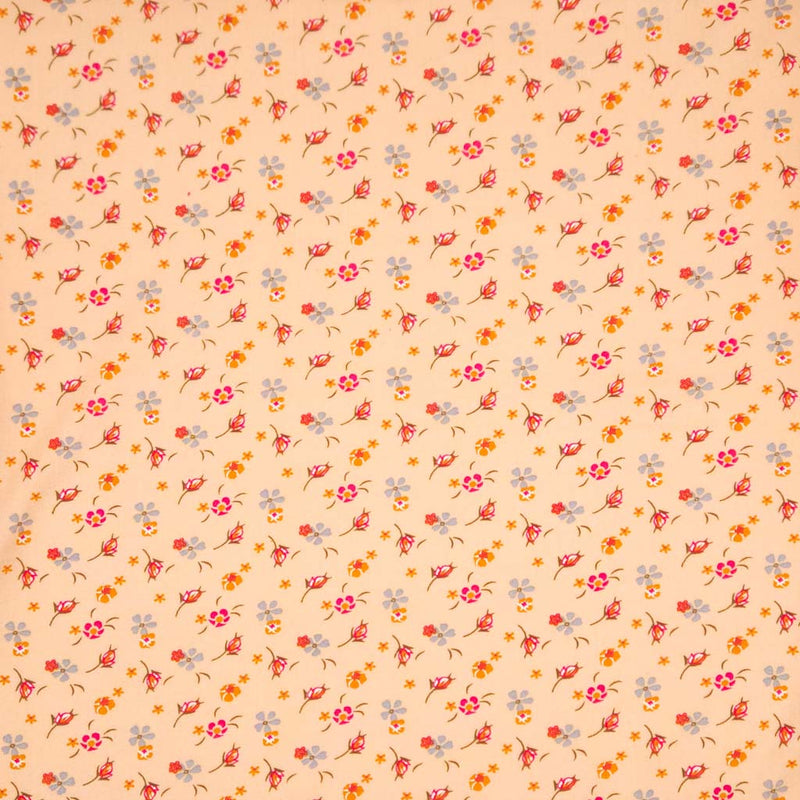 Floral patterned fabric with a swirl design on a peach viscose fabric