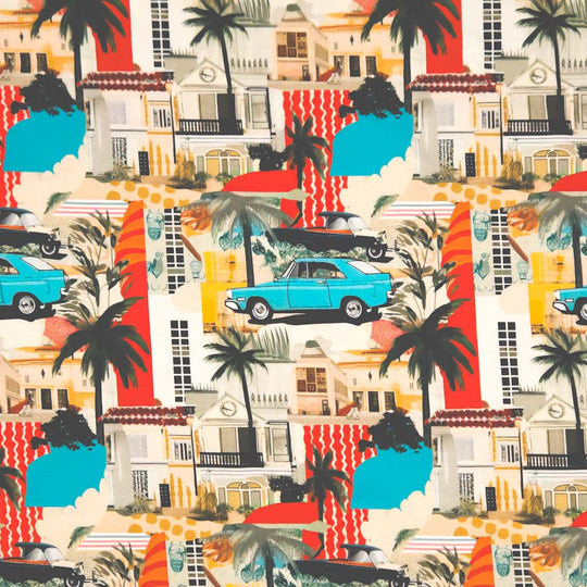 A cool graphic design featuring a vintage blue car traveling amongst palm trees, holiday houses and bold areas of stripy red and blue patchwork, digitally printed on a cotton jersey fabric